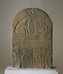 Stela of the vulture goddess Nekhbet of Nekheb dedicated by a priest of the Temple of Horus Behdety who is shown in the top register, found at Edfu